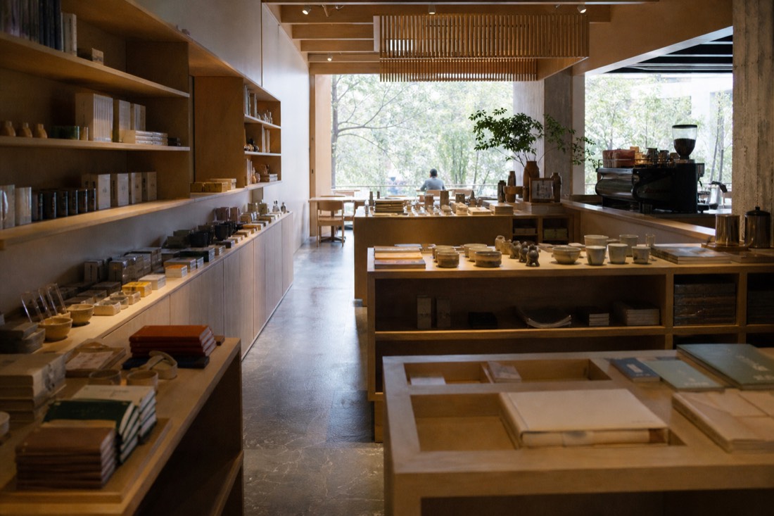 Rows of framed tickets and a museum map spread on a table beside a coffee cup
